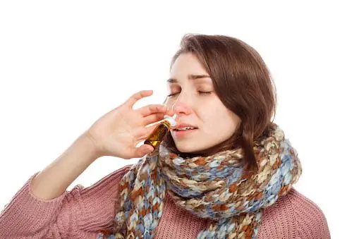 girl dropping mustard oil in nostril